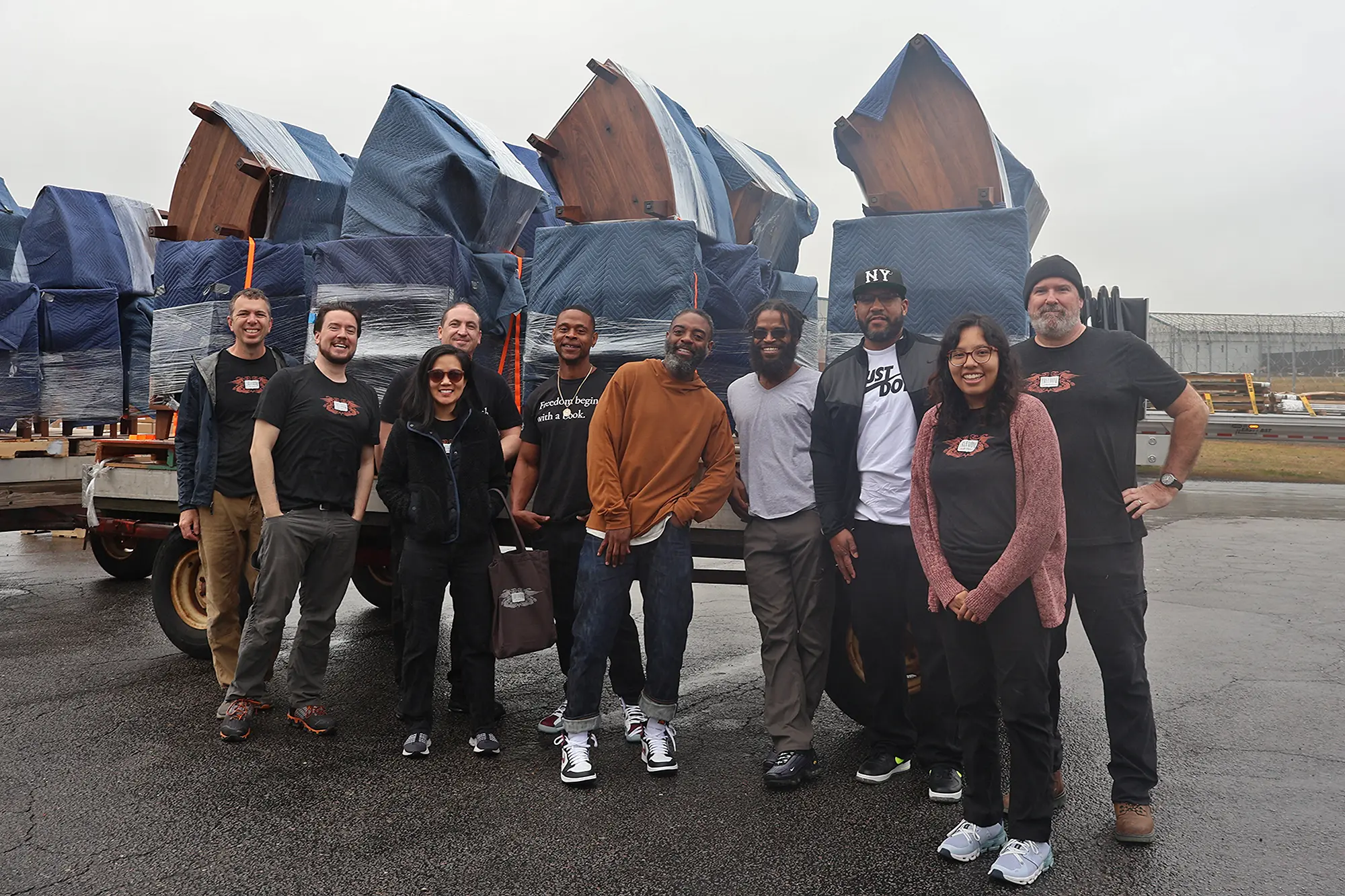 The Freedom Reads team stands in front of multiple Freedom Library bookcase units stacked and ready to be unpacked and installed at Dillwyn Correctional Center in Virginia.