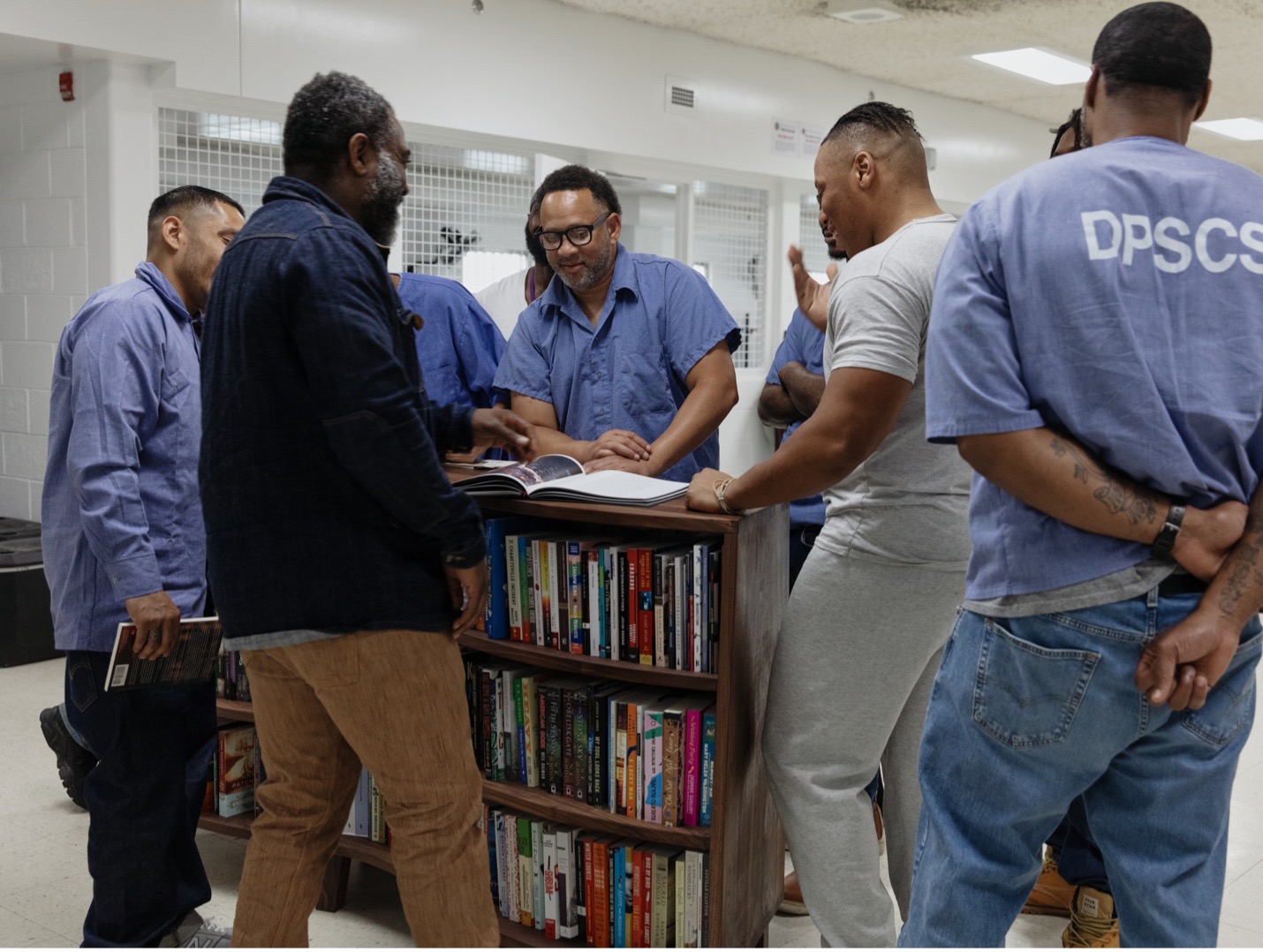 Men at the Dorsey Run Correctional Facility in Jessup, Maryland, with Freedom Reads Founder & CEO Reginald Dwayne Betts, after helping Freedom Reads’ team members open Freedom Libraries there in June 2023.