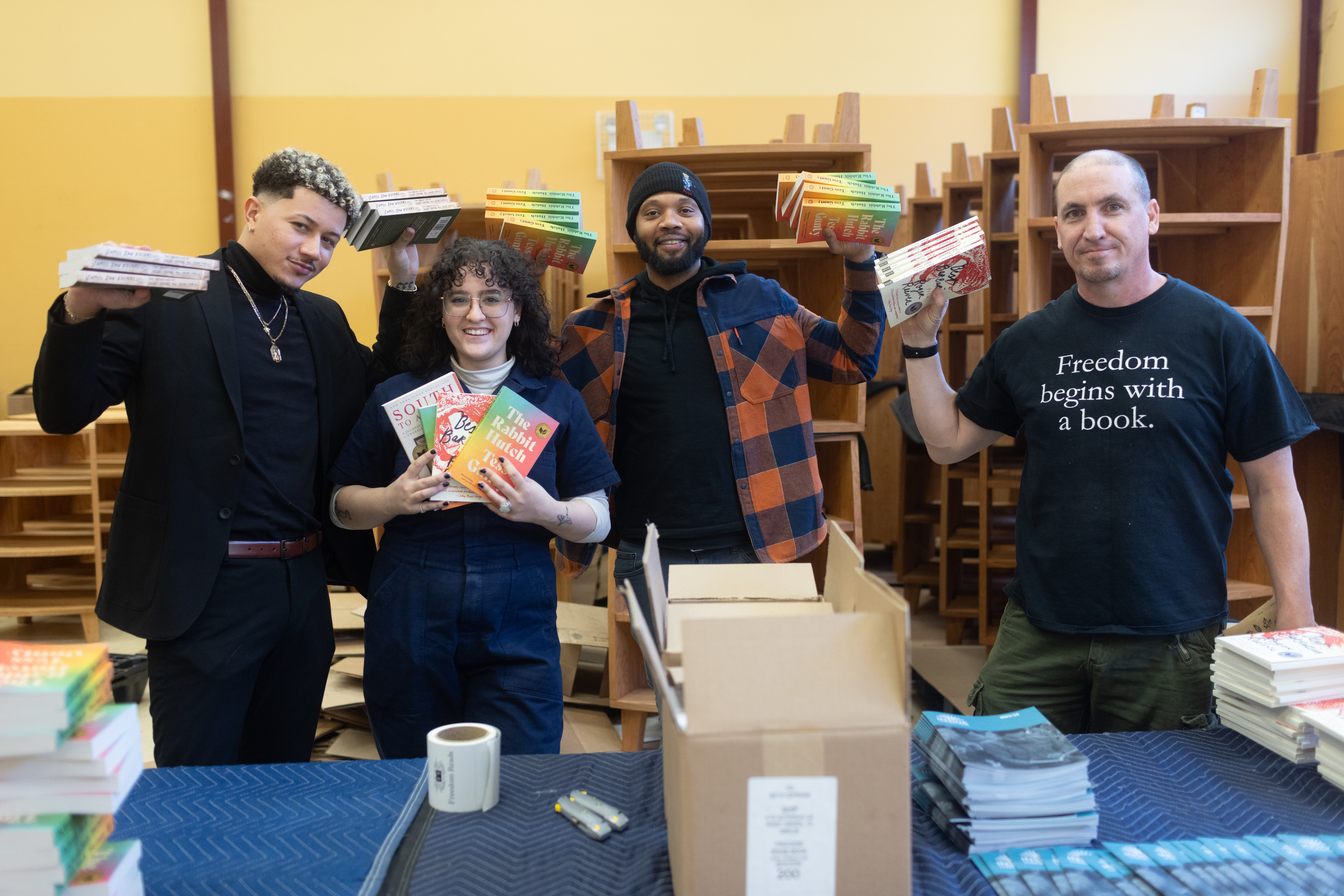 Freedom Reads team members (from left to right) David, Gabby, Mike, and Steven with the four books shortlisted for the Inside Literary Prize.