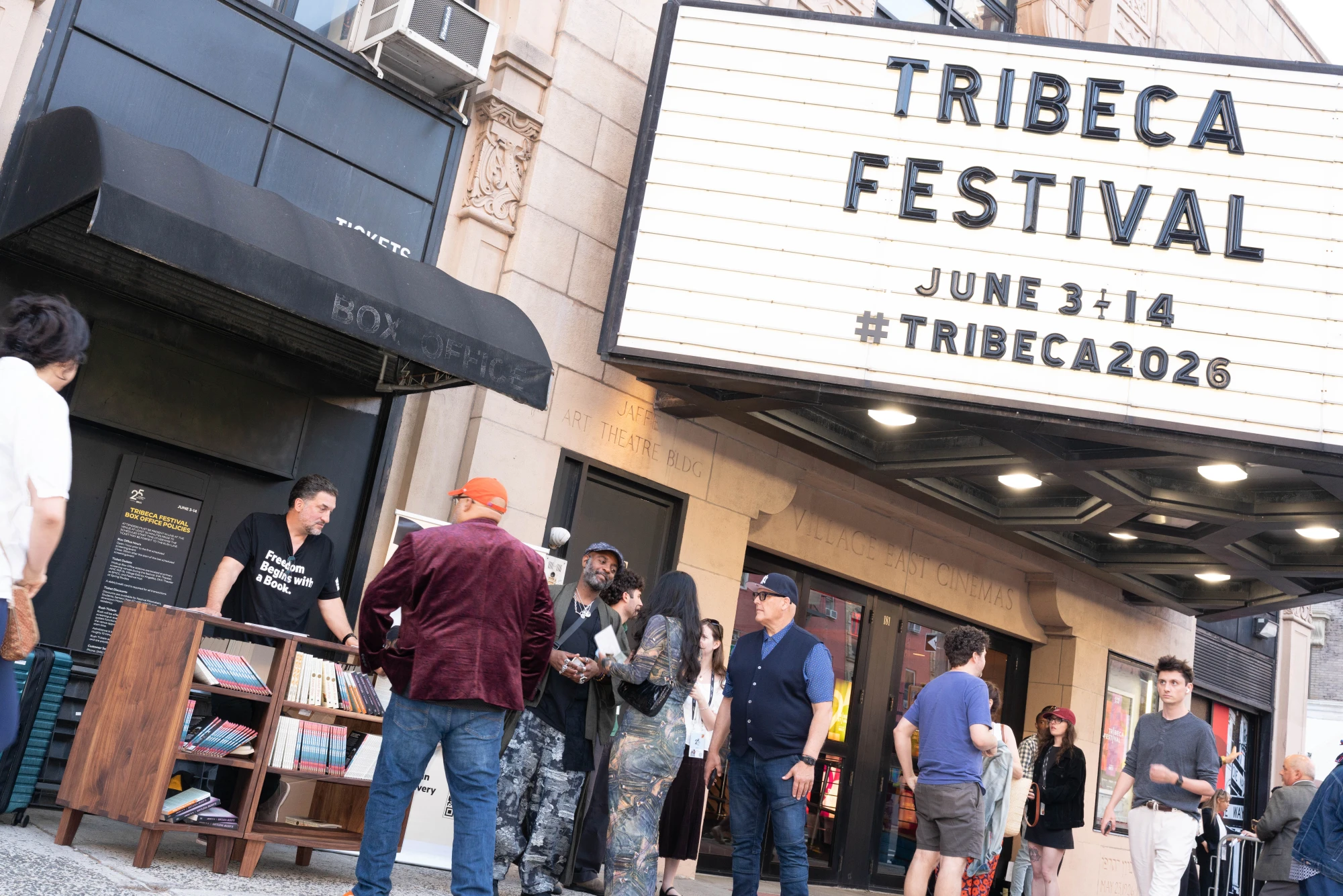 Crowd in front of a Tribeca Festival theater. Handcrafted wooden bookshelves on display.