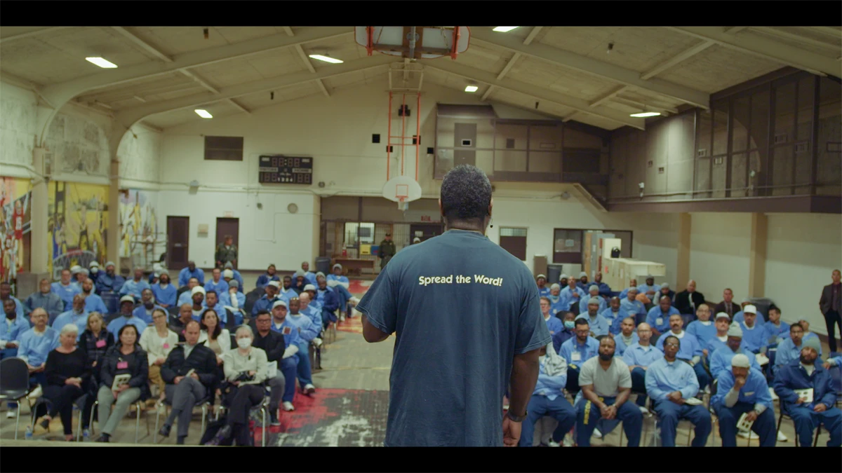 Man in front of an audience in prison