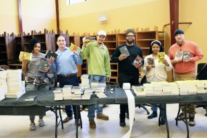 Six members of the Freedom Reads team hold Inside Literary Prize 2025 books and pose for a photo.