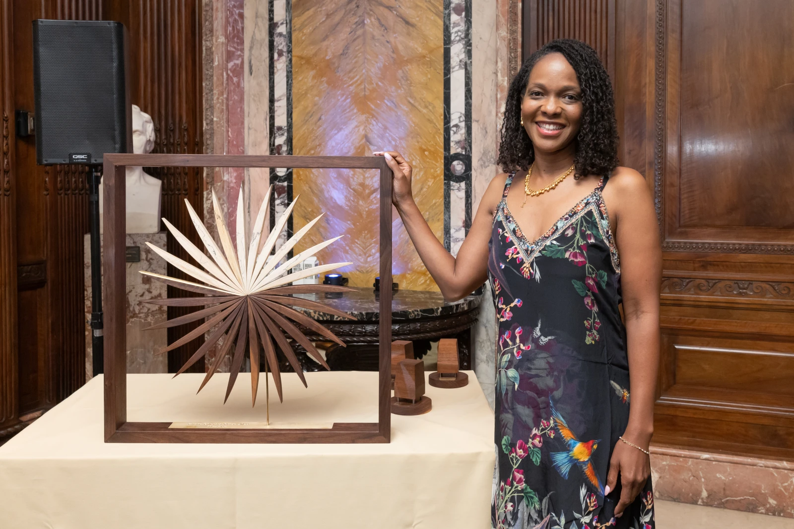 Imani Perry stands, smiling with the Inside Literary Prize award.